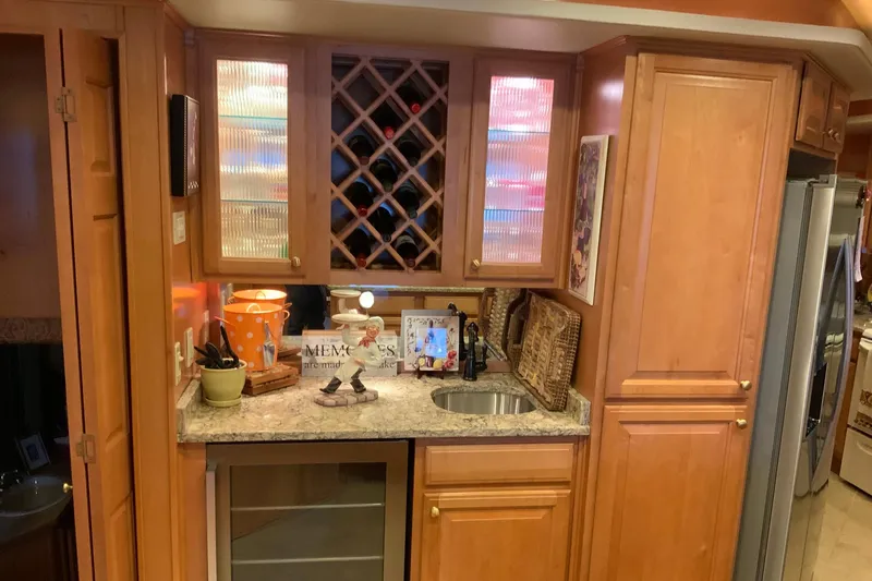 Slide: The Image of Luxurious 2004 Sumerset 18 x 87 houseboat kitchen with wood cabinets and wine rack. - 41