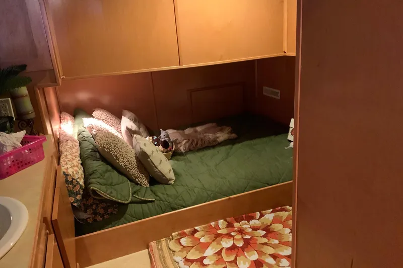 Slide: The Image of Cozy bedroom in 2004 Sumerset 18 x 87 houseboat with green bedding and decorative pillows. - 44