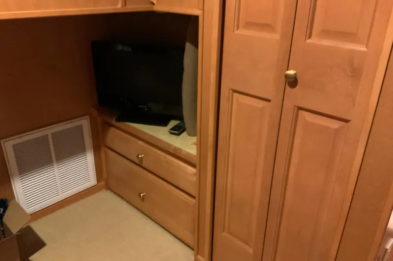 Slide: The Image of Wooden cabinetry with TV and drawers in 2004 Sumerset 18 x 87 houseboat interior. - 46
