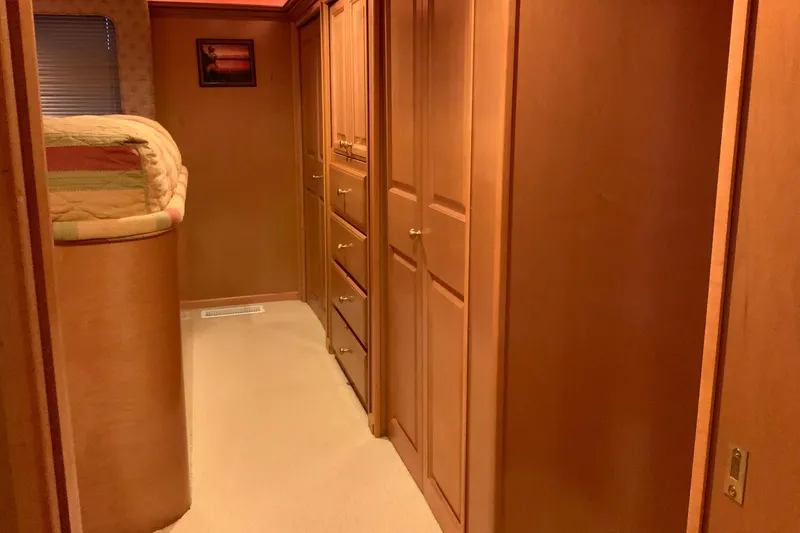 Slide: The Image of Interior hallway of 2004 Sumerset 18 x 87 houseboat with wood paneling and storage. - 48