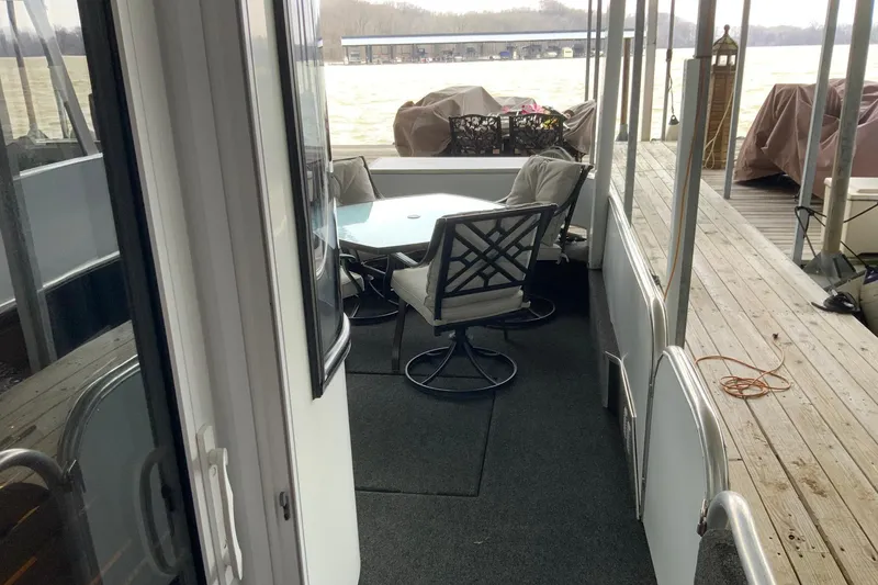 Slide: The Image of 2004 Sumerset 18 x 87 houseboat deck with outdoor seating and lake view. - 7