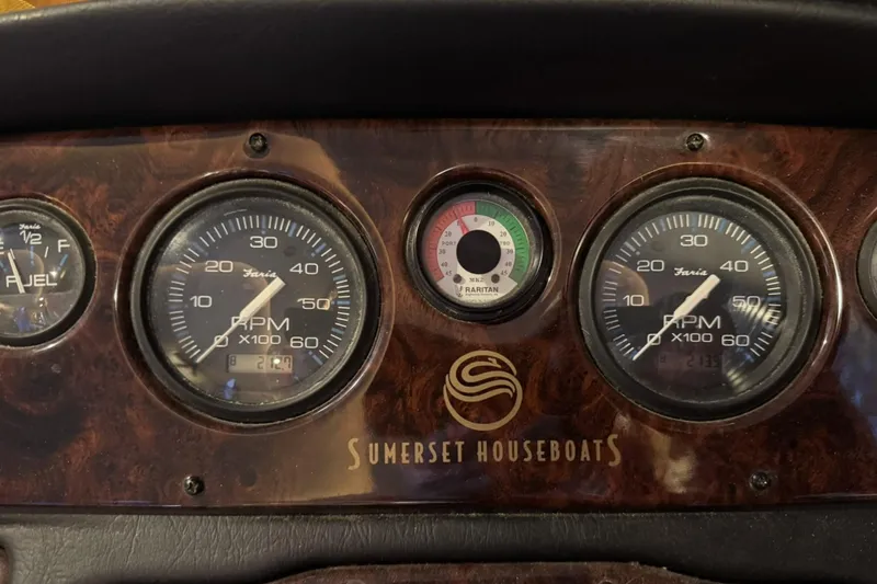 Slide: The Image of Dashboard of a 2004 Sumerset 18 x 87 houseboat with RPM and fuel gauges. - 9