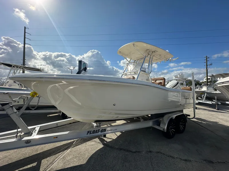 The Image of 2025 Pioneer 222 Sportfish boat on trailer under sunny sky. - 1