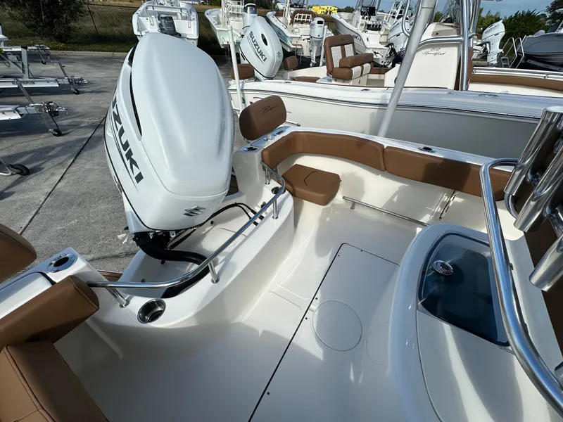 Slide: The Image of 2025 Pioneer 222 Sportfish boat with Suzuki outboard motor, featuring tan seating and sleek design. - 12