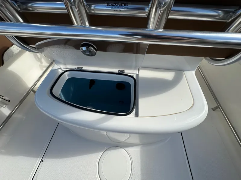 Slide: The Image of 2025 Pioneer 222 Sportfish boat livewell with stainless steel railing. - 13