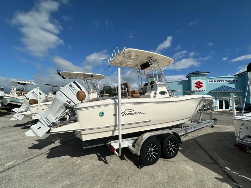 Slide: The Image of 2025 Pioneer 222 Sportfish boat on trailer at Palm City Yachts dealership. - 3