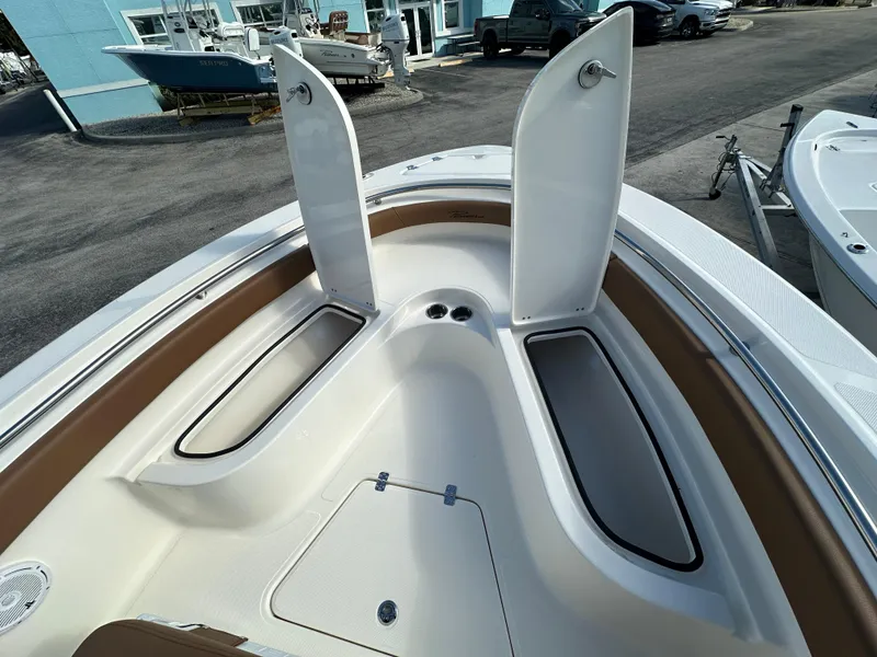 Slide: The Image of 2025 Pioneer 222 Sportfish boat with open storage compartments on deck. - 8