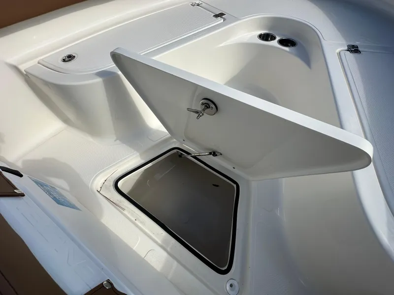 Slide: The Image of 2025 Pioneer 222 Sportfish boat storage compartment with open hatch. - 9