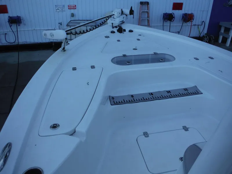 Slide: The Image of 2018 Sea Pro 248 Bay boat deck with storage compartments and measuring ruler. - 10