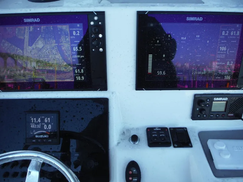 Slide: The Image of 2018 Sea Pro 248 Bay dashboard with Simrad navigation displays. - 19