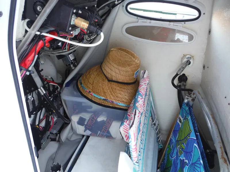 Slide: The Image of Interior storage of 2018 Sea Pro 248 Bay boat with beach gear and straw hat. - 25