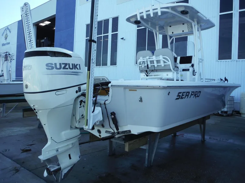 Slide: The Image of 2018 Sea Pro 248 Bay boat with Suzuki outboard motor, docked at marina. - 3