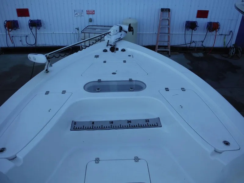 Slide: The Image of 2018 Sea Pro 248 Bay boat deck with storage compartments and measuring ruler. - 30