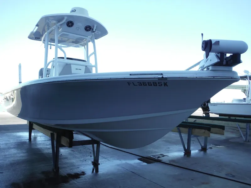 Slide: The Image of 2018 Sea Pro 248 Bay boat on display in a marina setting. - 4