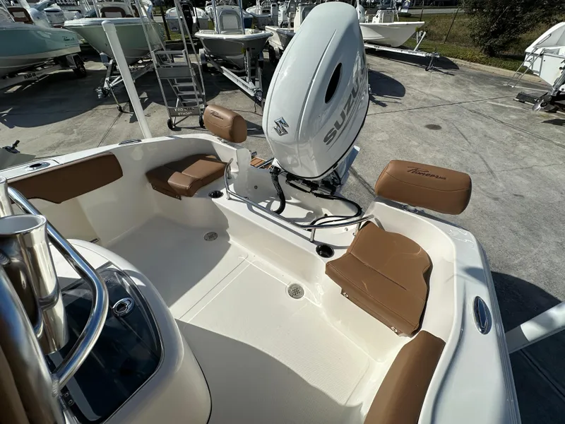Slide: The Image of 2025 Pioneer 202 Sportfish boat interior with seating and Suzuki outboard motor. - 10