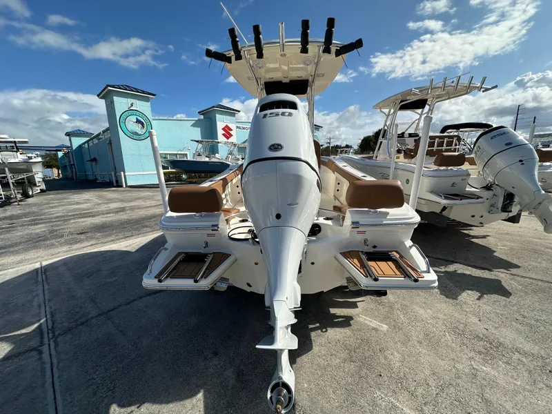 Slide: The Image of 2025 Pioneer 202 Sportfish boat with powerful outboard motor, docked under clear skies. - 4