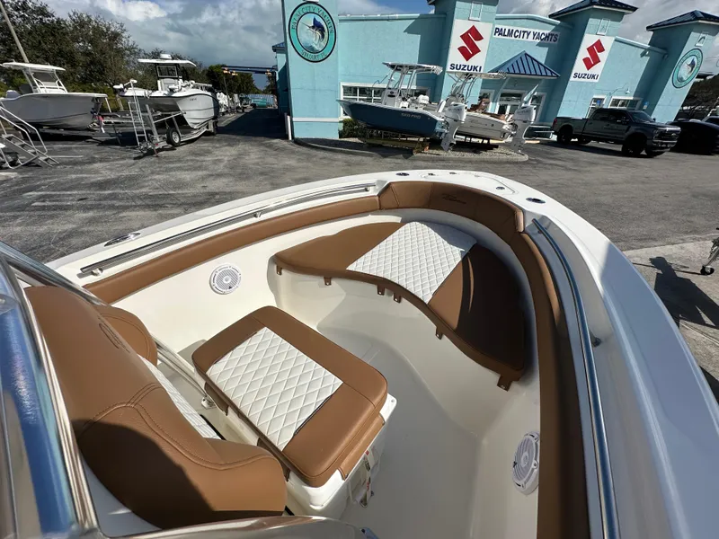 Slide: The Image of 2025 Pioneer 202 Sportfish boat interior with tan and white seating at Palmetto Yachts. - 6