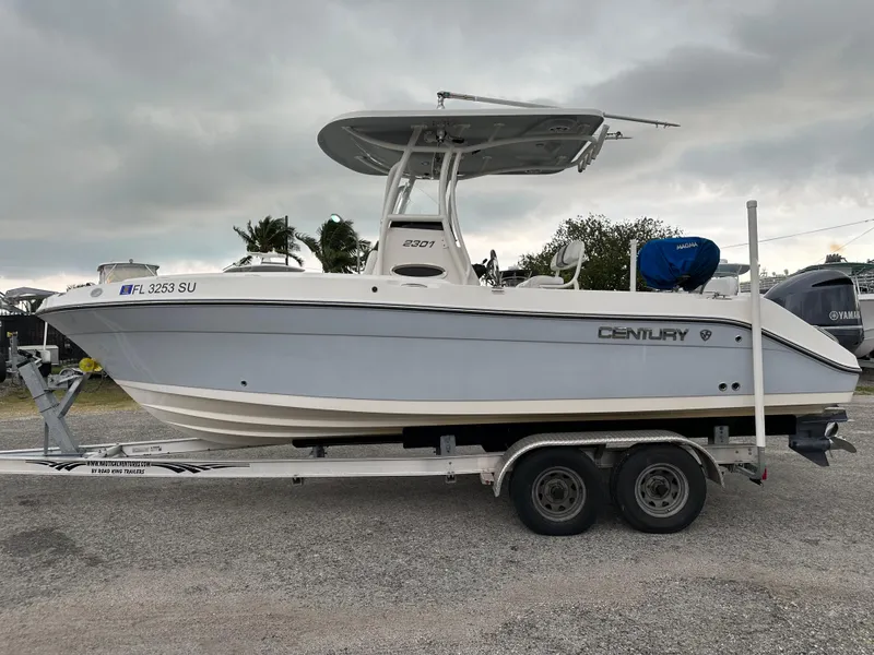 Slide: The Image of 2015 Century 2301 boat on trailer, side view, overcast sky. - 13