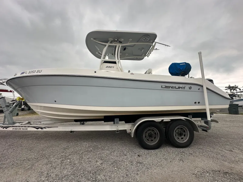 Slide: The Image of 2015 Century 2301 boat on trailer under cloudy sky. - 14