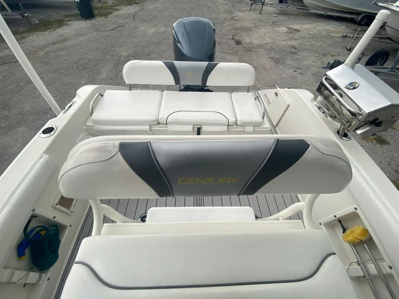 Slide: The Image of Century 2301 boat interior, 2015 model, featuring white seating and deck. - 21