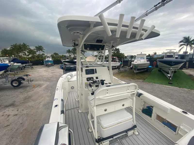 Slide: The Image of 2015 Century 2301 boat with center console, docked in a marina under cloudy skies. - 22