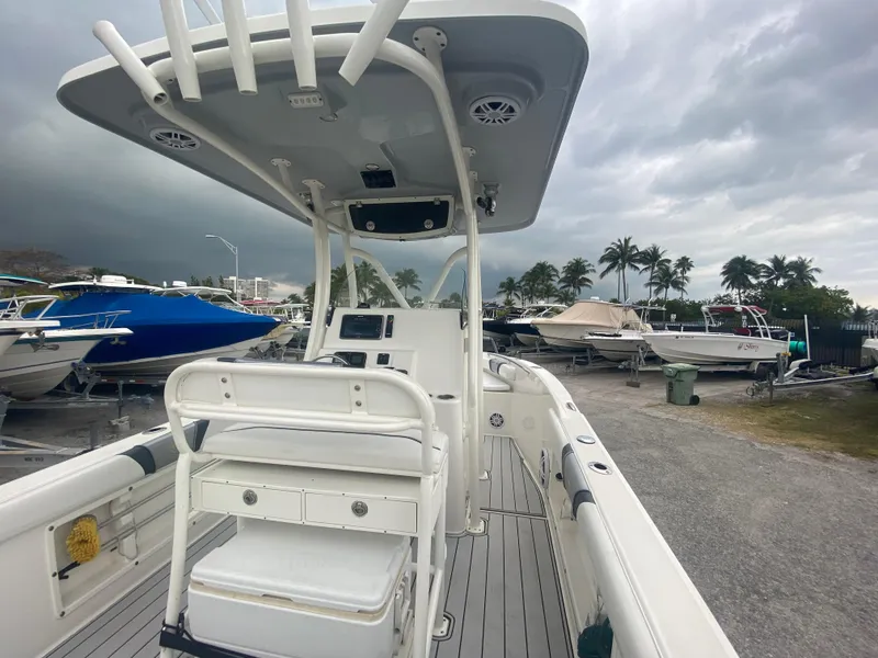 Slide: The Image of 2015 Century 2301 boat with T-top, docked under cloudy skies. - 24