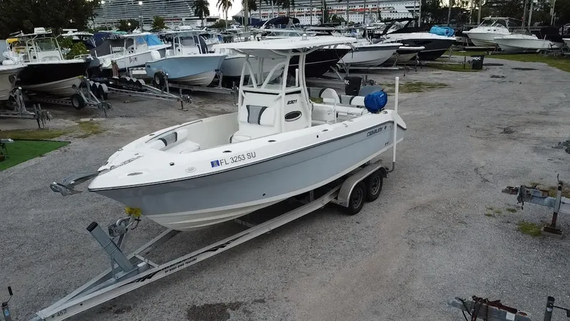 Slide: The Image of 2015 Century 2301 boat on trailer in marina, surrounded by other boats. - 3