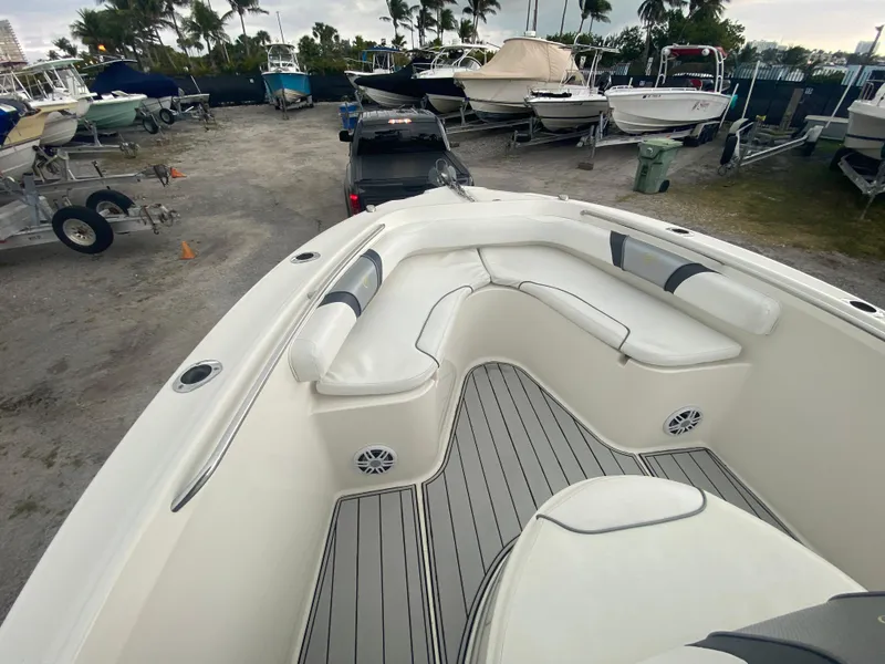 Slide: The Image of Century 2301 boat, 2015 model, with spacious seating, docked among other boats. - 32