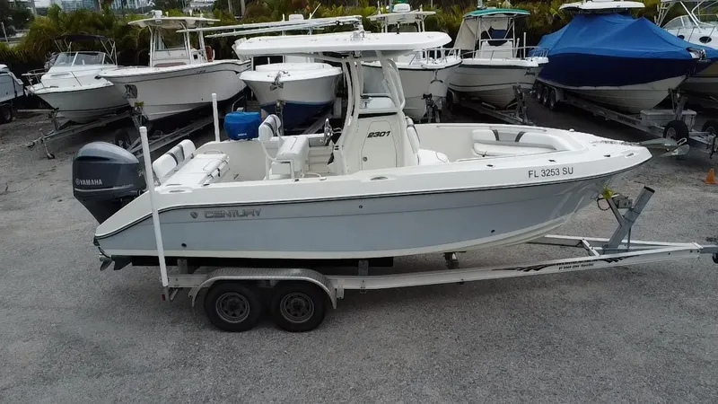 Slide: The Image of 2015 Century 2301 boat on trailer, parked among other boats. - 8