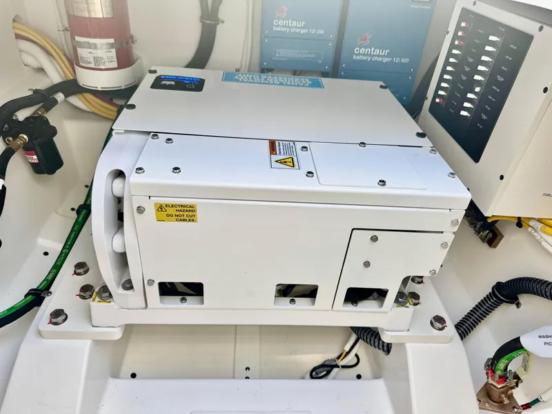 Slide: The Image of Engine compartment of 2025 Tiara Yachts 34 LX with electrical components and wiring. - 30