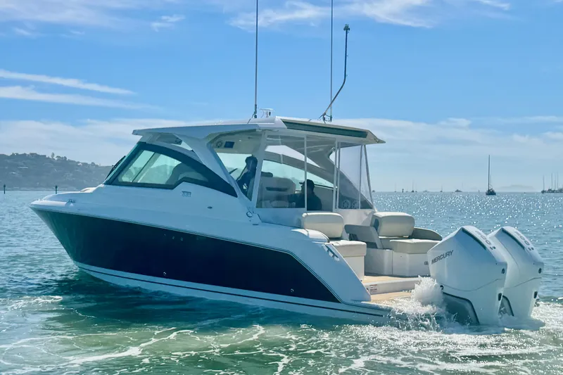 Slide: The Image of 2026 Tiara Yachts 34 LX cruising on a sunny day with twin Mercury engines. - 4