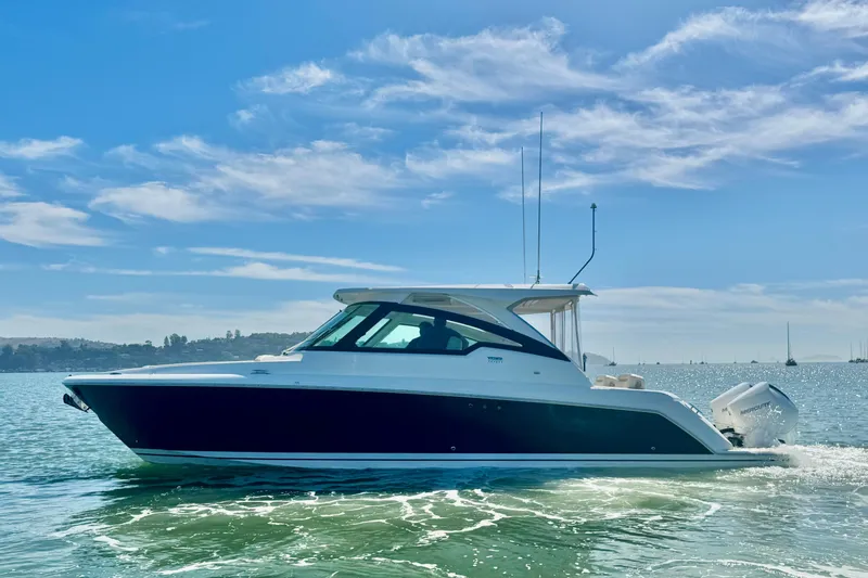 Slide: The Image of 2026 Tiara Yachts 34 LX cruising on a sunny day, showcasing sleek design. - 5