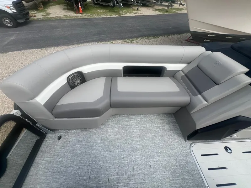 Slide: The Image of 2024 Premier 230 SunSation RF boat interior with gray seating and speaker. - 3