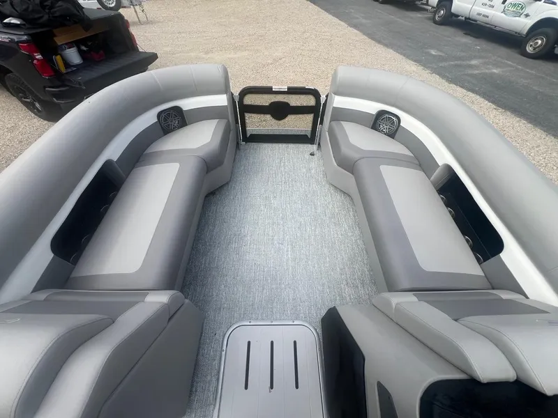 Slide: The Image of 2024 Premier 230 SunSation RF pontoon boat interior with gray seating and flooring. - 4