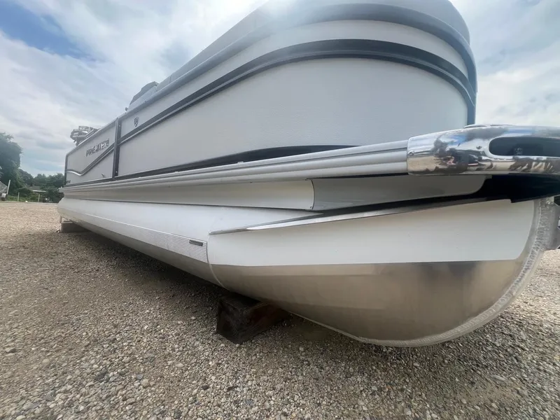 Slide: The Image of 2024 Premier 230 SunSation RF pontoon boat on gravel, side view. - 9