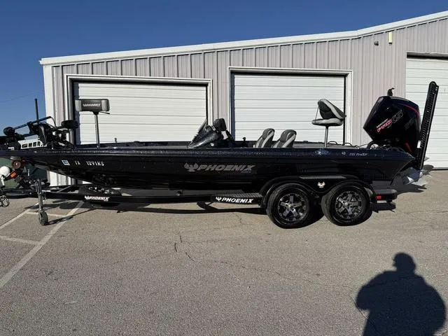 Slide: The Image of 2022 Phoenix 721 Pro XP boat parked outside a garage on a sunny day. - 1
