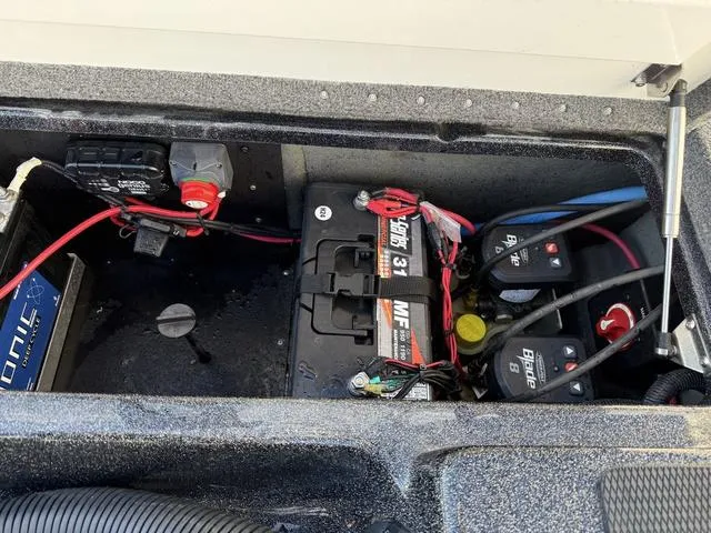 Slide: The Image of 2022 Phoenix 721 Pro XP boat battery compartment with wiring and components. - 25