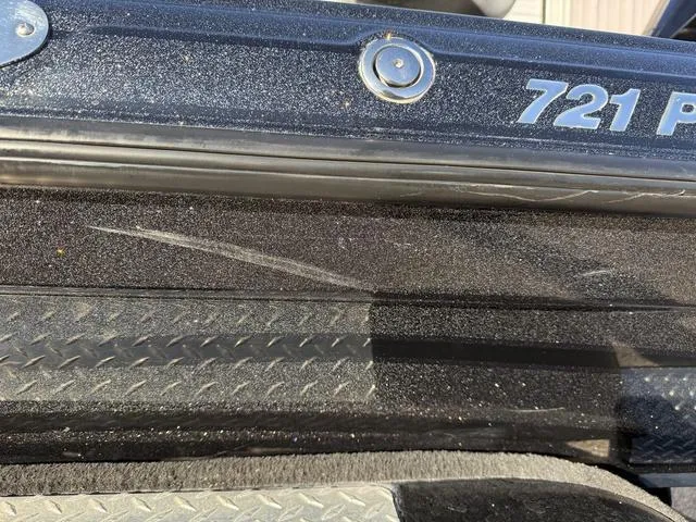 Slide: The Image of Close-up of 2022 Phoenix 721 Pro XP boat with visible scratch on black surface. - 30