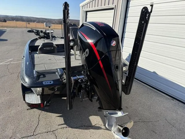 Slide: The Image of 2022 Phoenix 721 Pro XP boat with powerful outboard motor, parked near a garage. - 4