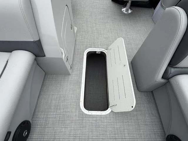 Slide: The Image of 2025 Bentley Pontoons Legacy 243 Navigator interior storage compartment with open hatch. - 11