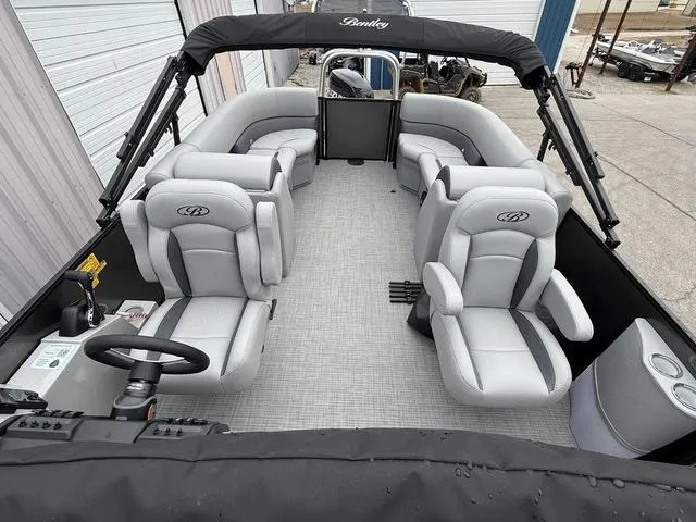 Slide: The Image of 2025 Bentley Pontoons Legacy 243 Navigator interior with plush seating and modern design. - 17