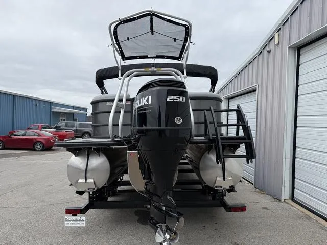 Slide: The Image of 2025 Bentley Pontoons Legacy 243 Navigator with Suzuki 250 engine, parked near industrial buildings. - 3