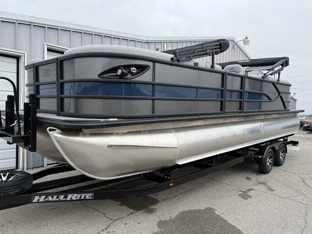 Slide: The Image of 2025 Bentley Pontoons Legacy 243 Navigator on trailer, sleek design, gray exterior. - 5