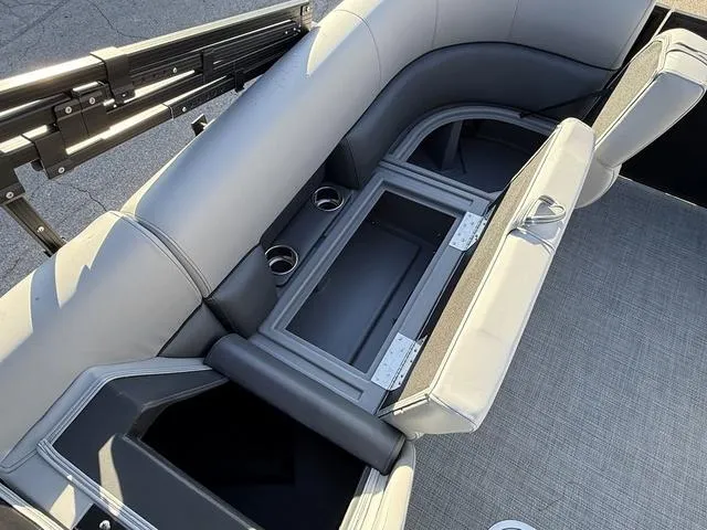 Slide: The Image of 2025 Bentley Pontoons Legacy 223 Navigator interior seating with storage compartments and cup holders. - 11