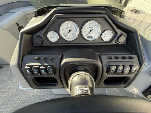 Slide: The Image of 2025 Bentley Pontoons Legacy 223 Navigator dashboard with gauges and controls. - 15