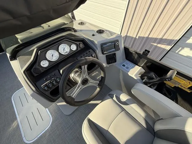 Slide: The Image of 2025 Bentley Pontoons Legacy 223 Navigator dashboard with steering wheel and gauges. - 16