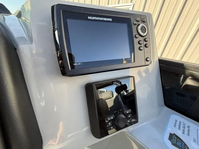 Slide: The Image of 2025 Bentley Pontoons Legacy 223 Navigator dashboard with Humminbird Helix 5 and JBL controls. - 17