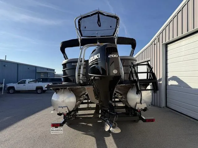 Slide: The Image of 2025 Bentley Pontoons Legacy 223 Navigator with Suzuki 200 engine, parked outdoors. - 4