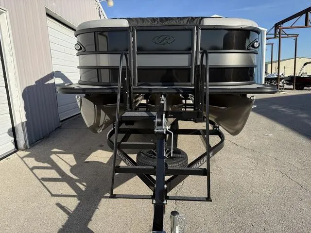 Slide: The Image of 2025 Bentley Pontoons Legacy 223 Navigator on trailer, front view in outdoor setting. - 7