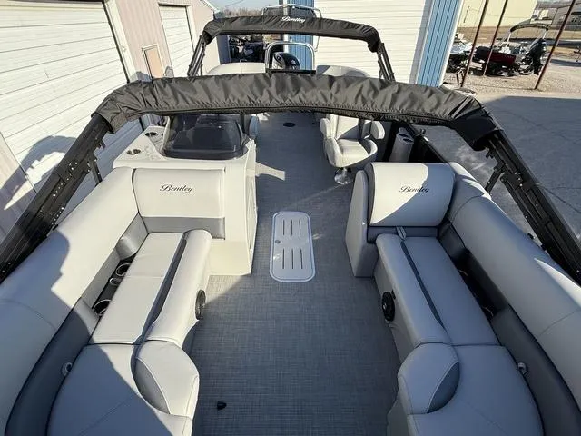 Slide: The Image of 2025 Bentley Pontoons Legacy 223 Navigator interior with gray seating and spacious layout. - 9